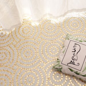Bedroom floor scene featuring circular gold and white mosaic tiles