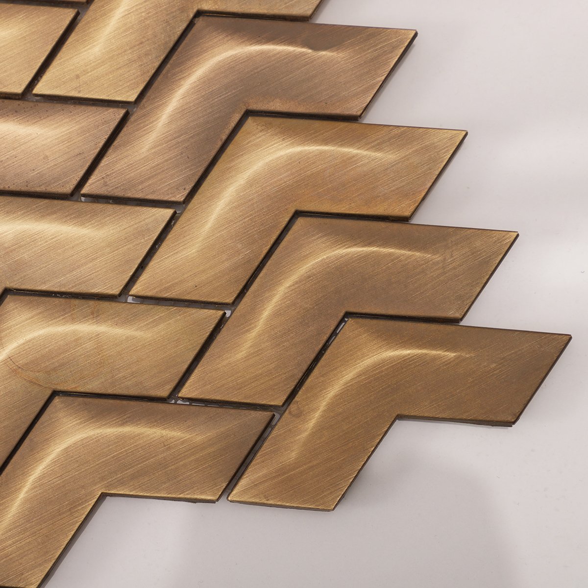 Close-up of Chevron Brass Metal Mosaic Wall Tile, showing intricate brass texture