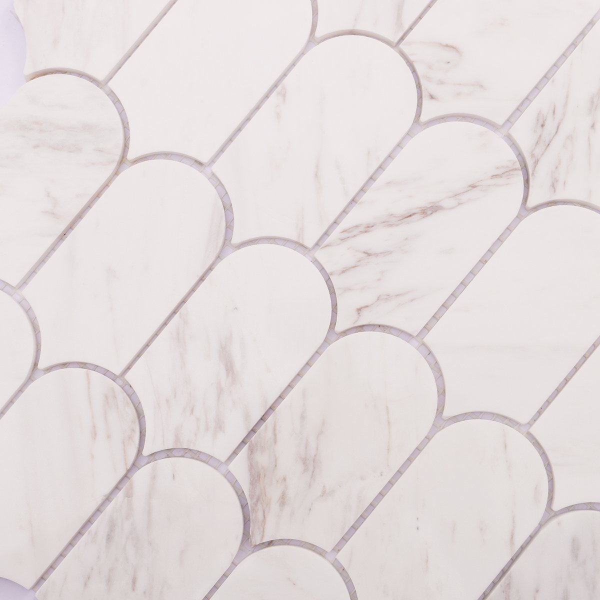 Close-up of white marble mosaic tile, showing light veins and smooth surface