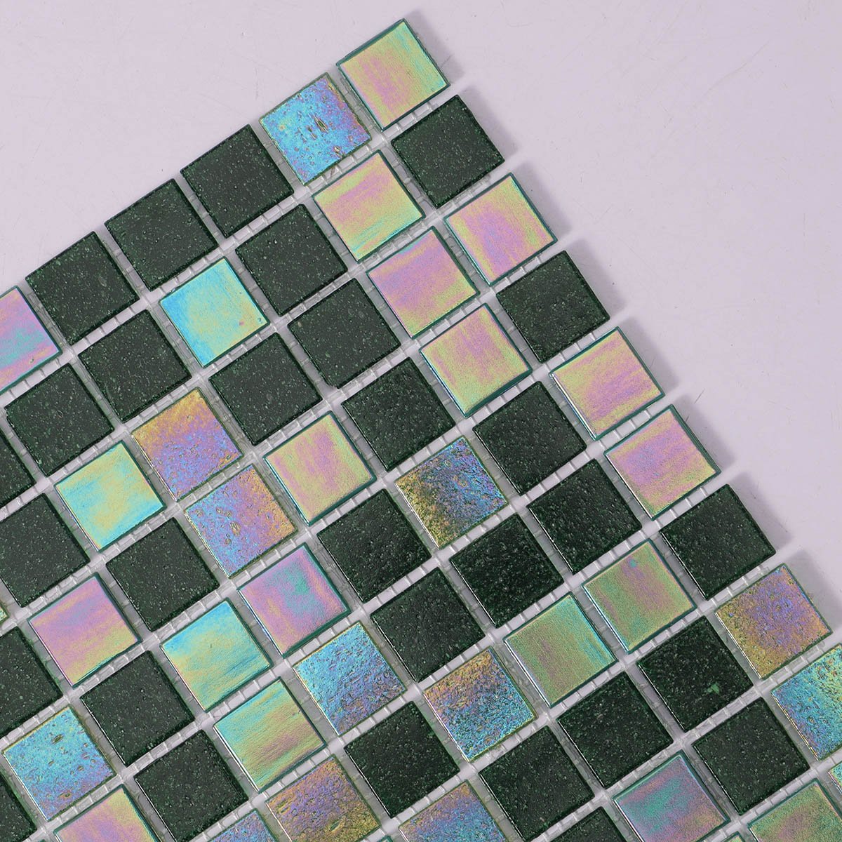 Detailed close-up of iridescent green square glass mosaic tiles