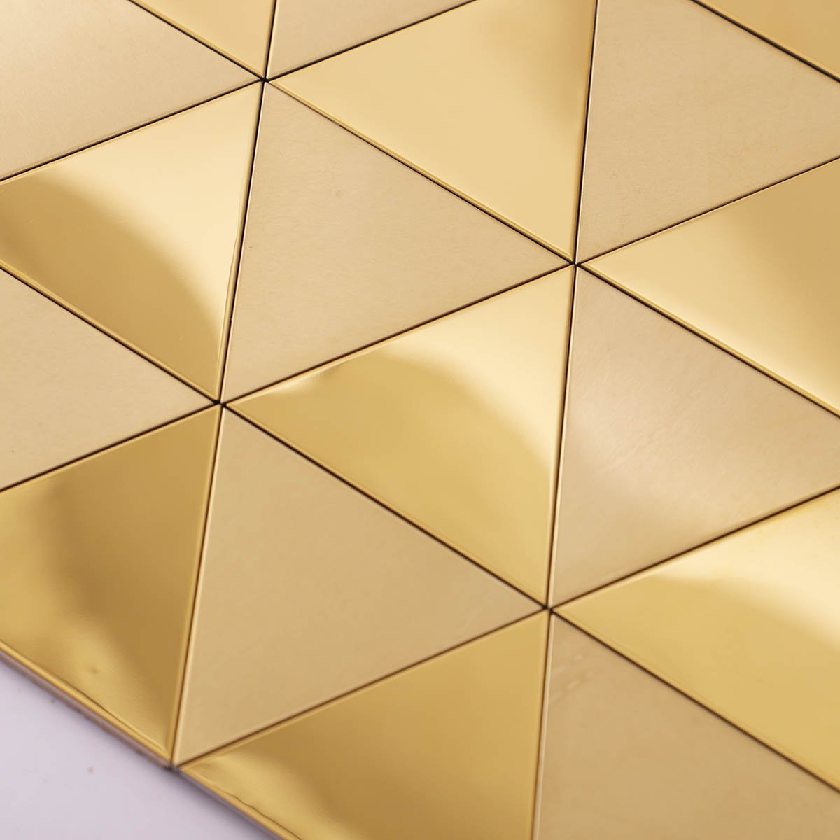 Close-up of gold triangle metal mosaic wall tiles