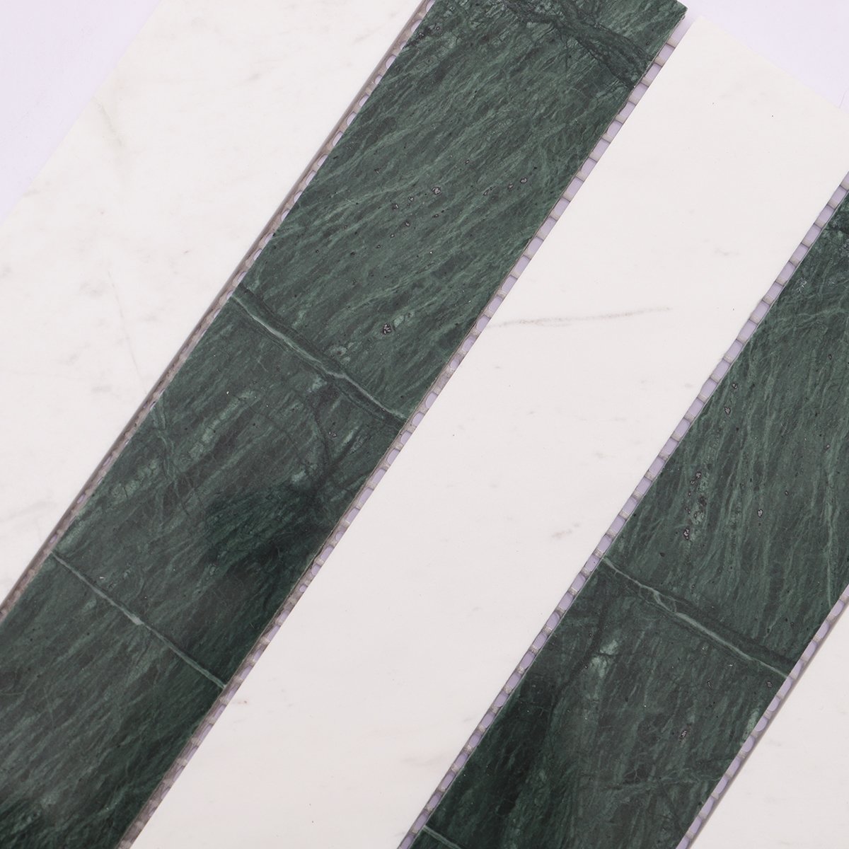 Close-up shot highlighting the surface of green marble and white marble strips
