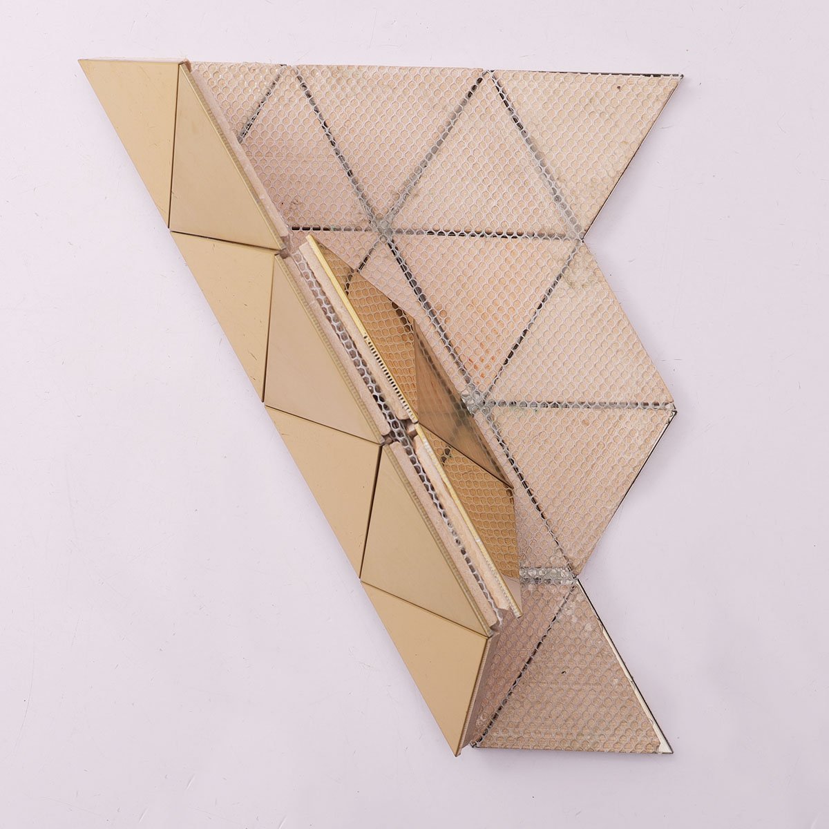 Folded back side of gold triangle metal mosaic wall tiles