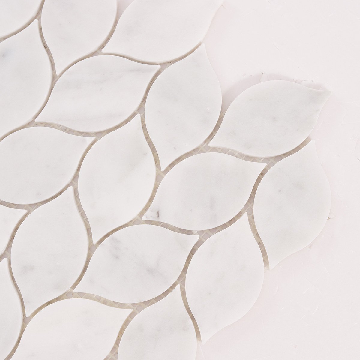 Detailed close-up of Carrara white leaf marble mosaic tiles