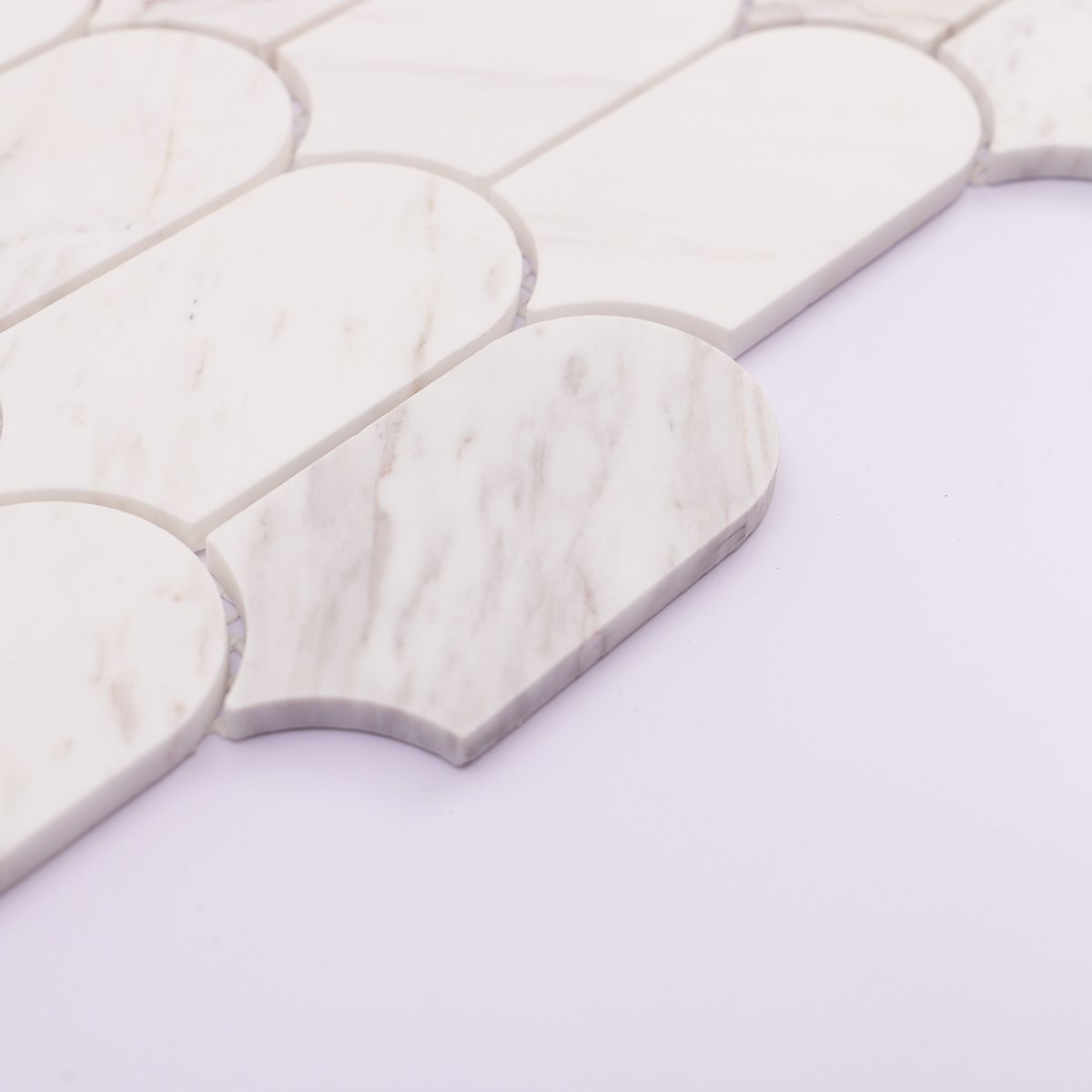 Side thickness detail of white marble mosaic tile, showing clean cut edges