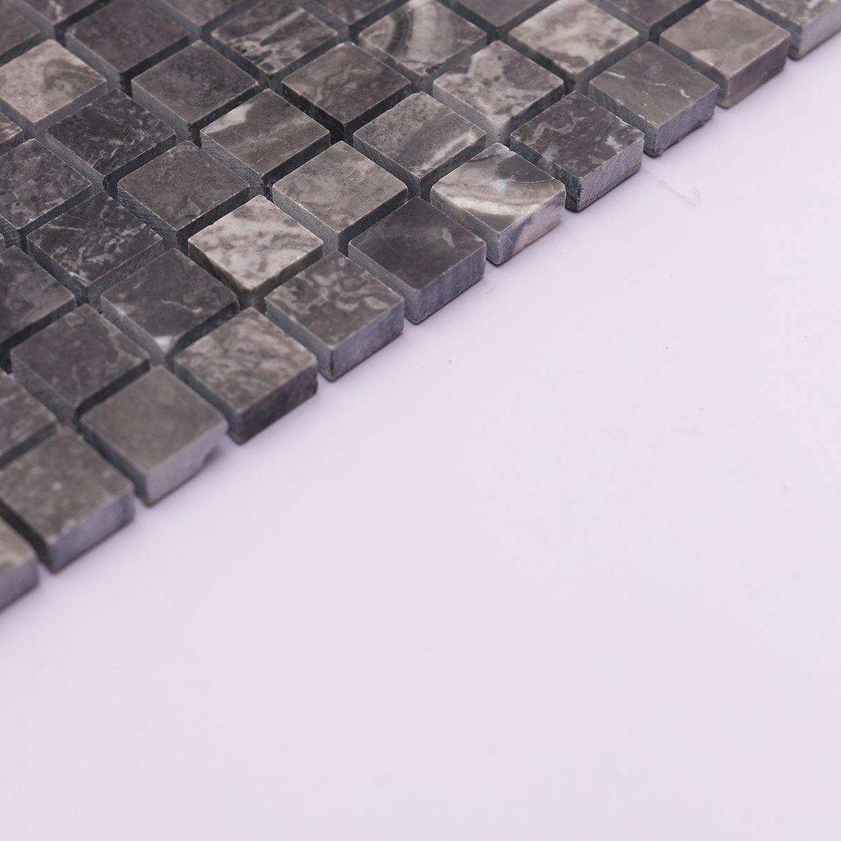 Side view showing the thickness of dark gray square slate mosaic tiles