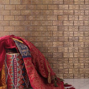 Copper subway mosaic with decorative patterns, white floor tiles, and a red stool