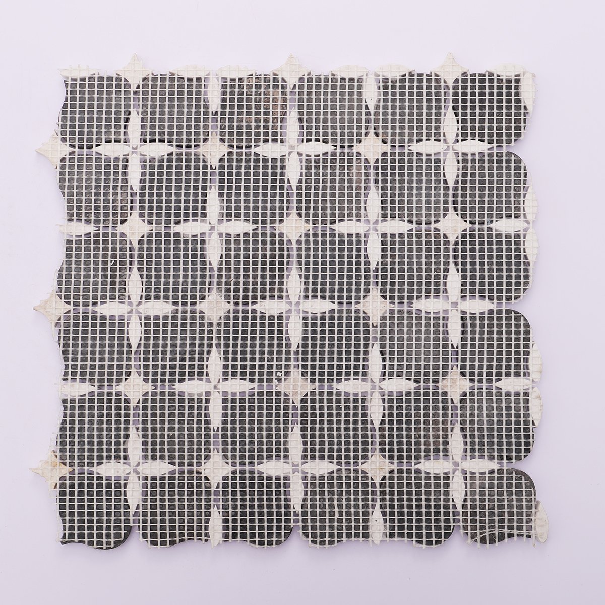 Black and white stone mosaic tiles with mesh backing for easy installation and secure fit.