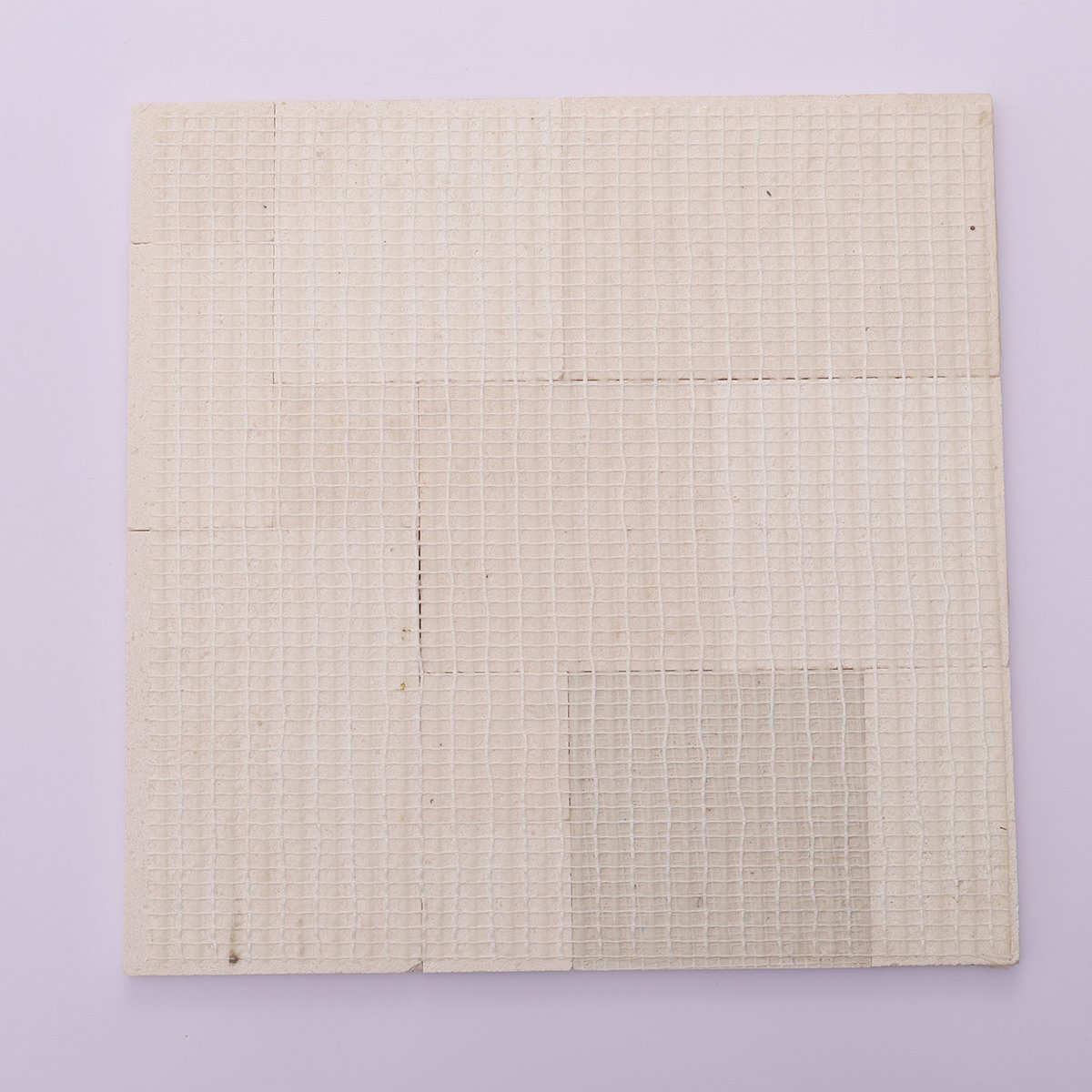 Back view with mesh backing of 3D beige square marble mosaic tiles.