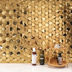 Hexagon gold 3D stainless steel mosaic tiles on a living room feature wall with white floor tiles.