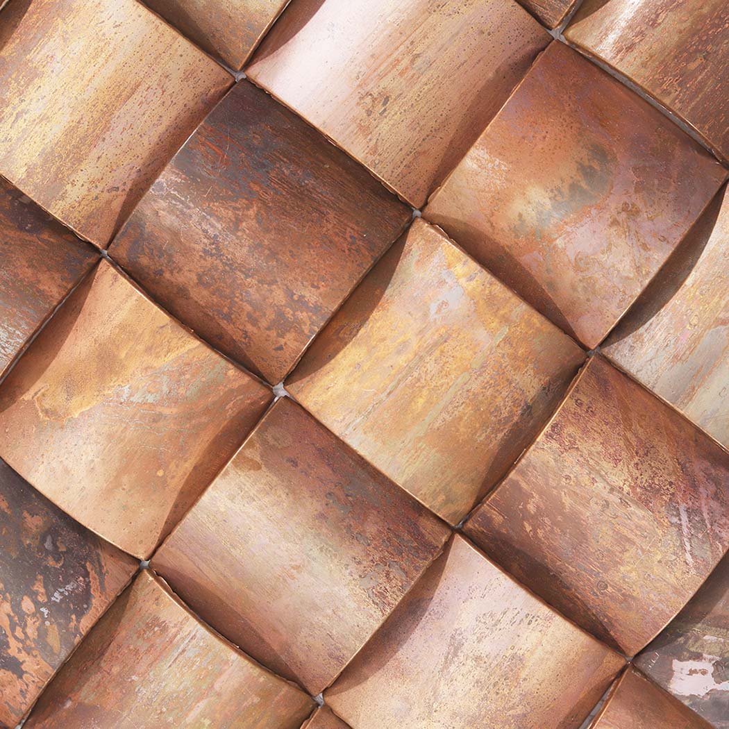 Close-up of antique copper 3D square metal mosaic tiles with varied aged tones