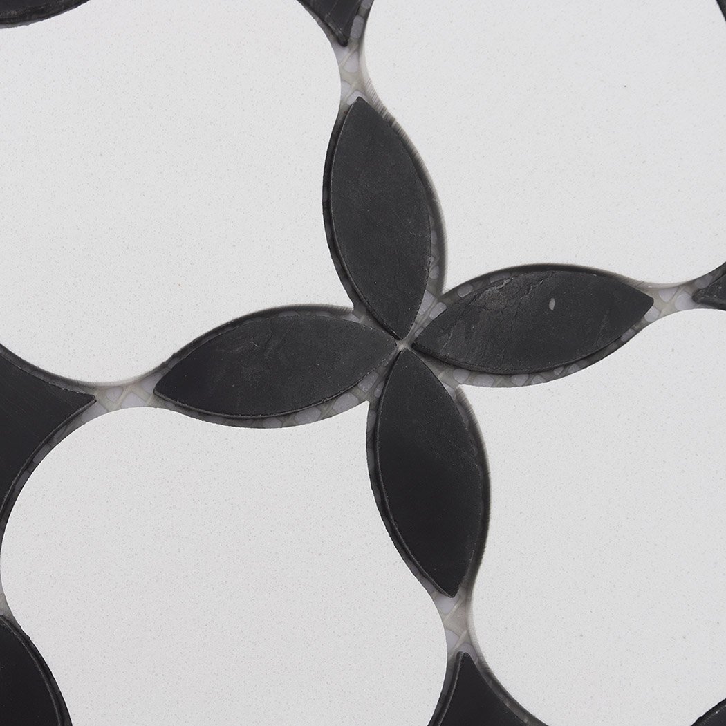 Black petal accents on a white floral waterjet mosaic tile