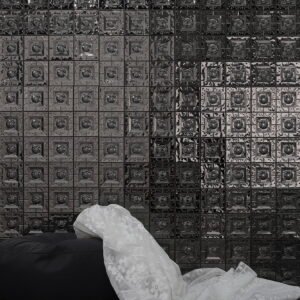 Interior space featuring black embossed metal mosaic tile wall design