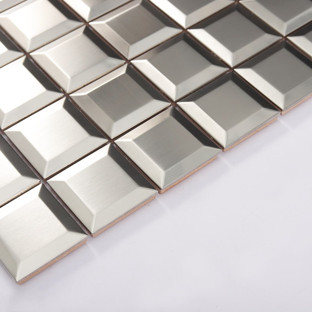Angled side view of brushed silver beveled stainless steel mosaic tiles