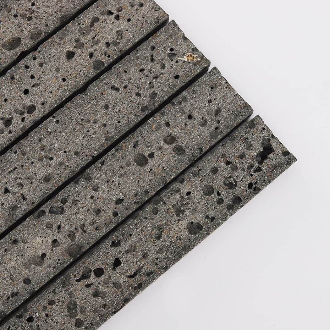 Close up shot showing the natural porous texture of lava stone mosaic tiles.
