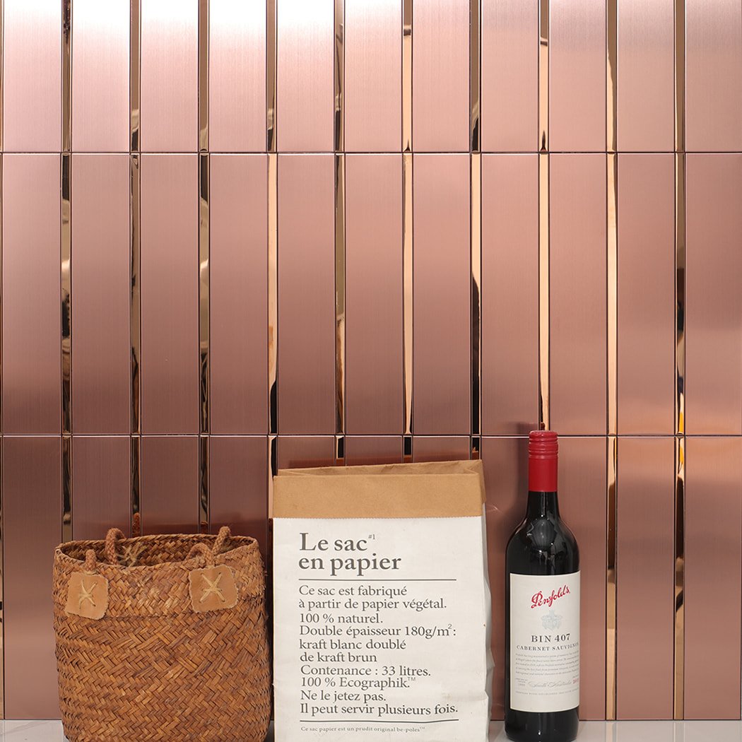 Rose gold metal wall tiles installed in a modern interior setting