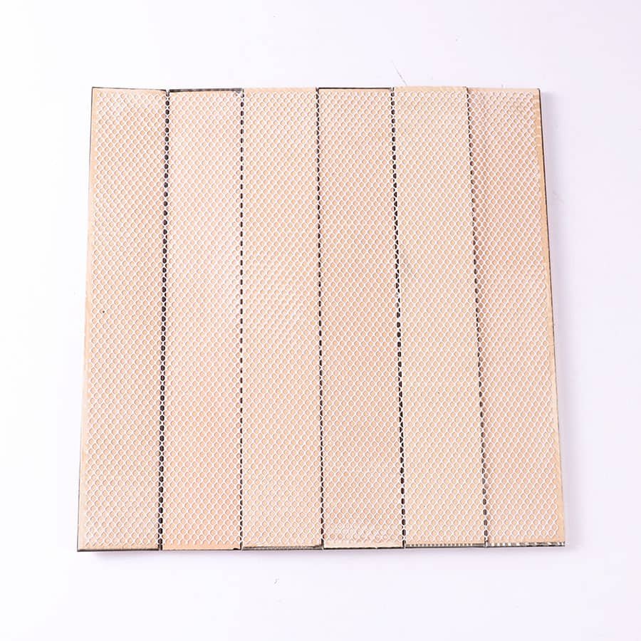 Back side of rose gold metal mosaic tile with beige mesh adhesive backing.