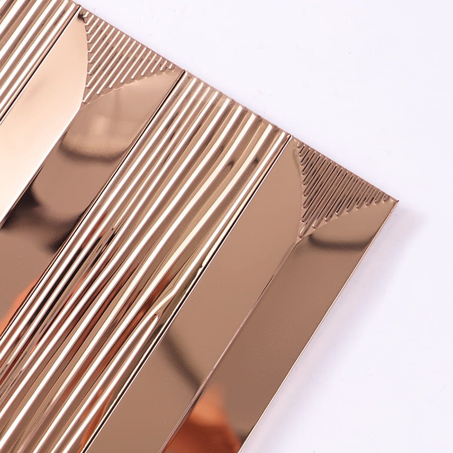 Close up showing reflective surface and ridged texture of rose gold metal tile.