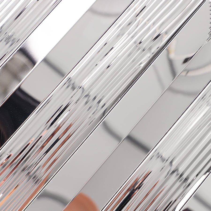 Detailed close up of silver metallic surface with alternating smooth and ribbed texture.