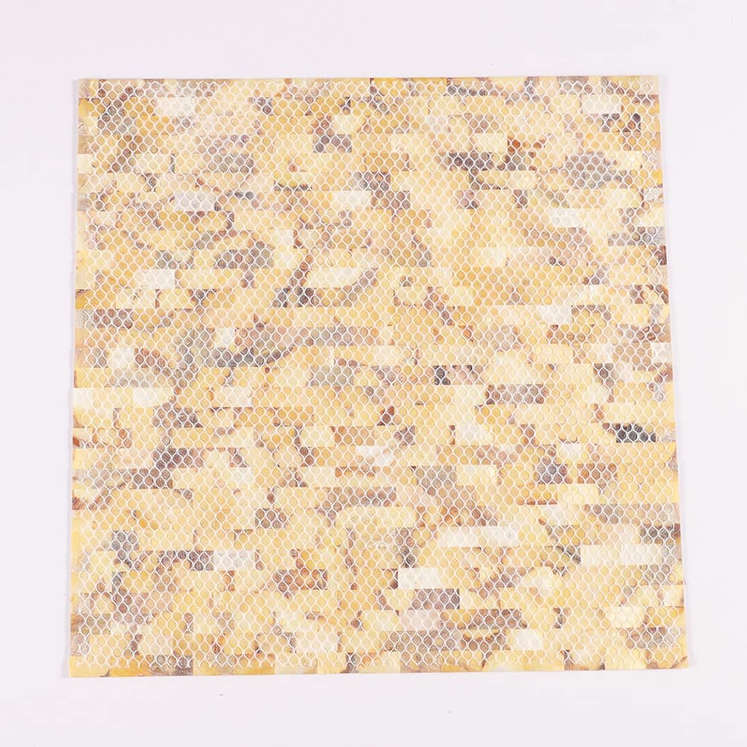 Back view of yellow mother of pearl shell mosaic with mesh backing.
