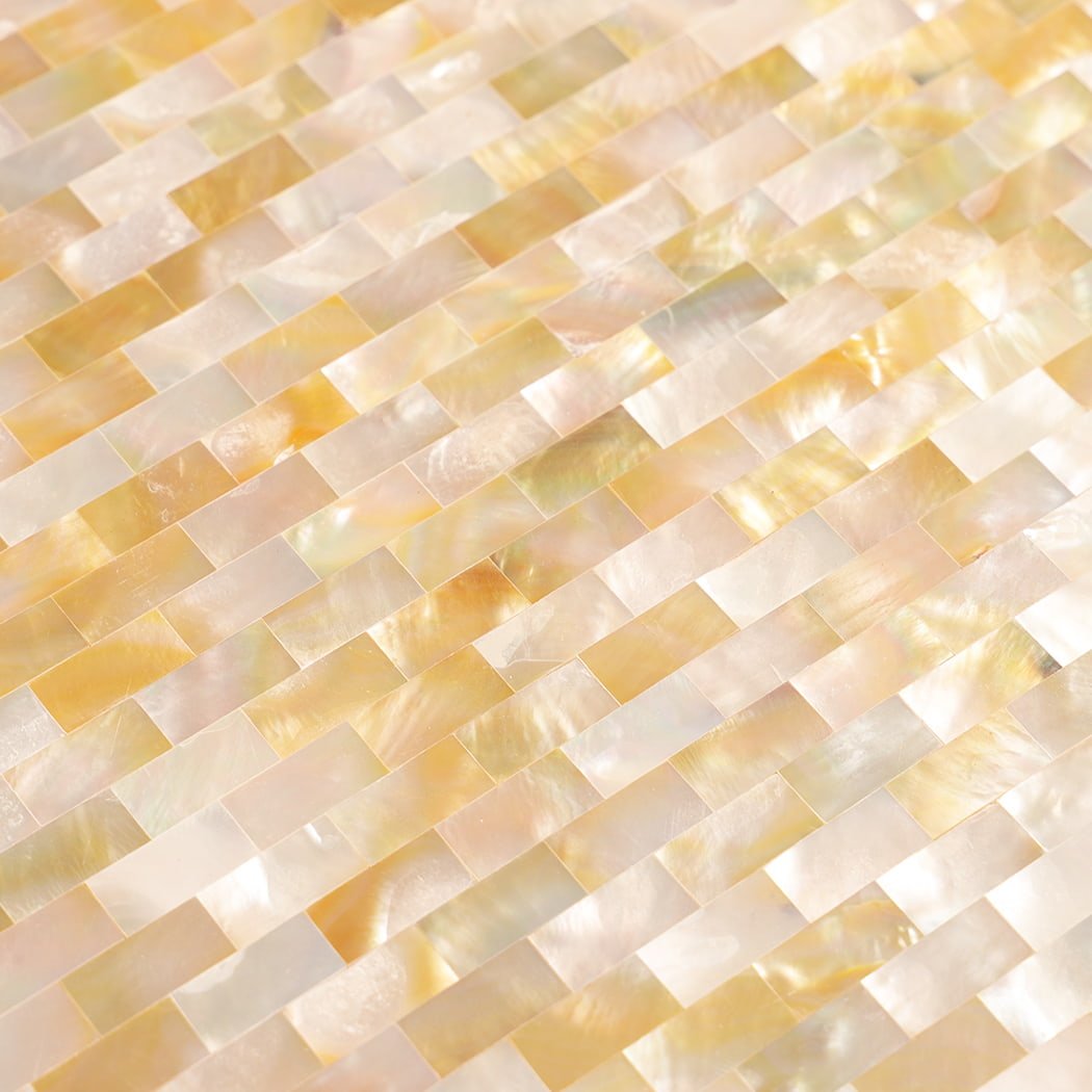 Close-up showing iridescent texture of yellow mother of pearl shell mosaic.