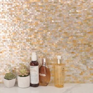 Yellow mother of pearl shell mosaic wall with skincare bottles and plants.