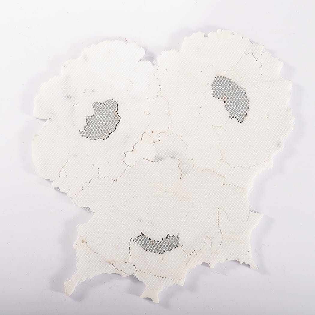 Back view of mesh-mounted white floral marble mosaic tile sheet.