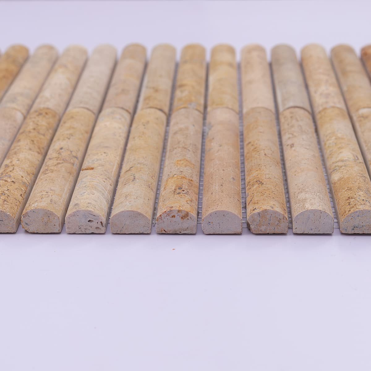 End view showing rounded curve of travertine fluted tiles
