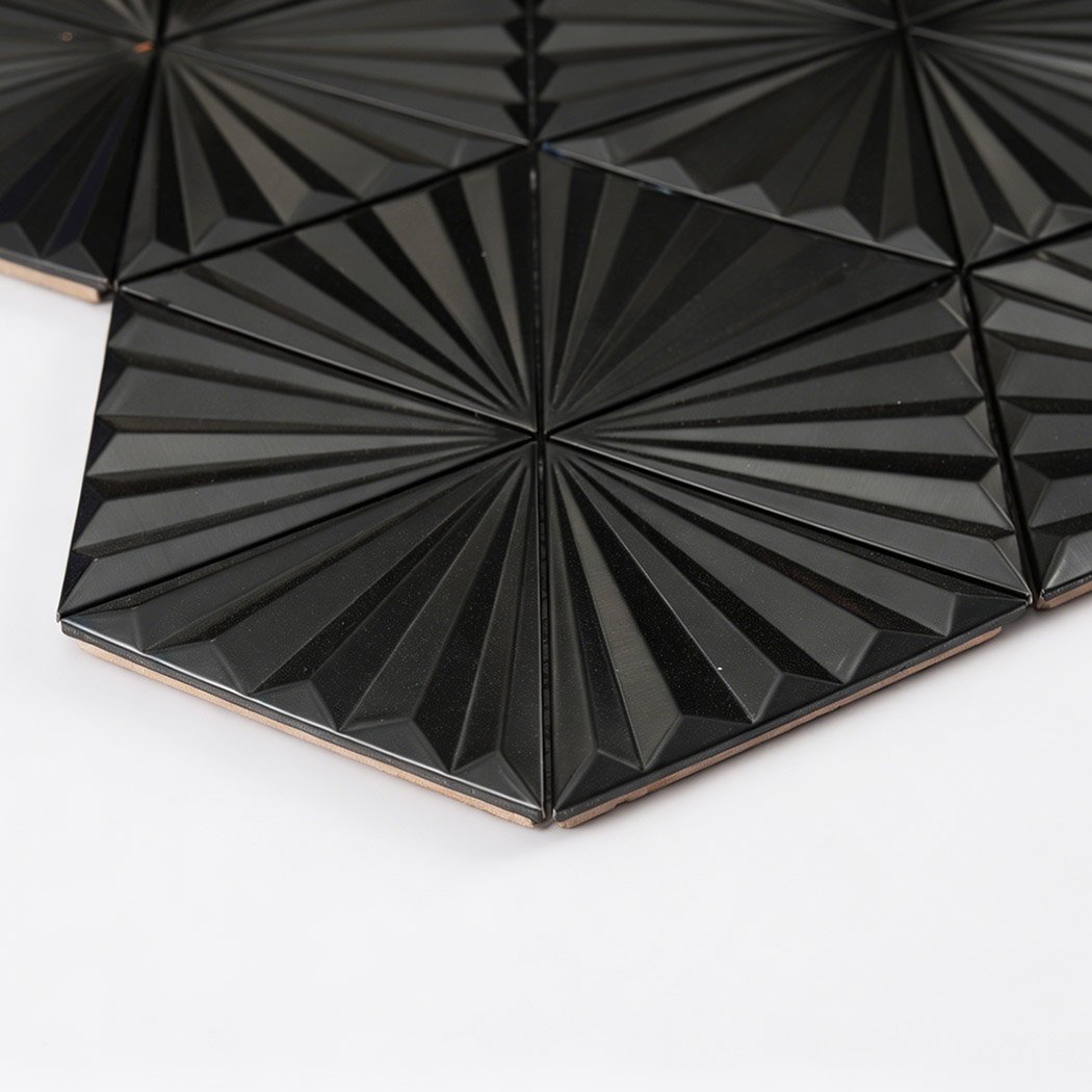 Edge detail of black fan triangle metal mosaic tile with raised ridges