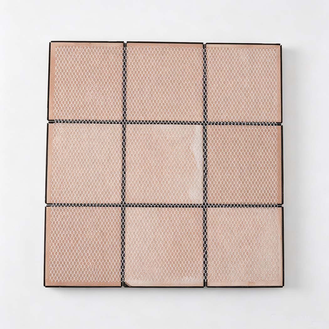 Back view of black square mosaic tile sheet with mesh backing