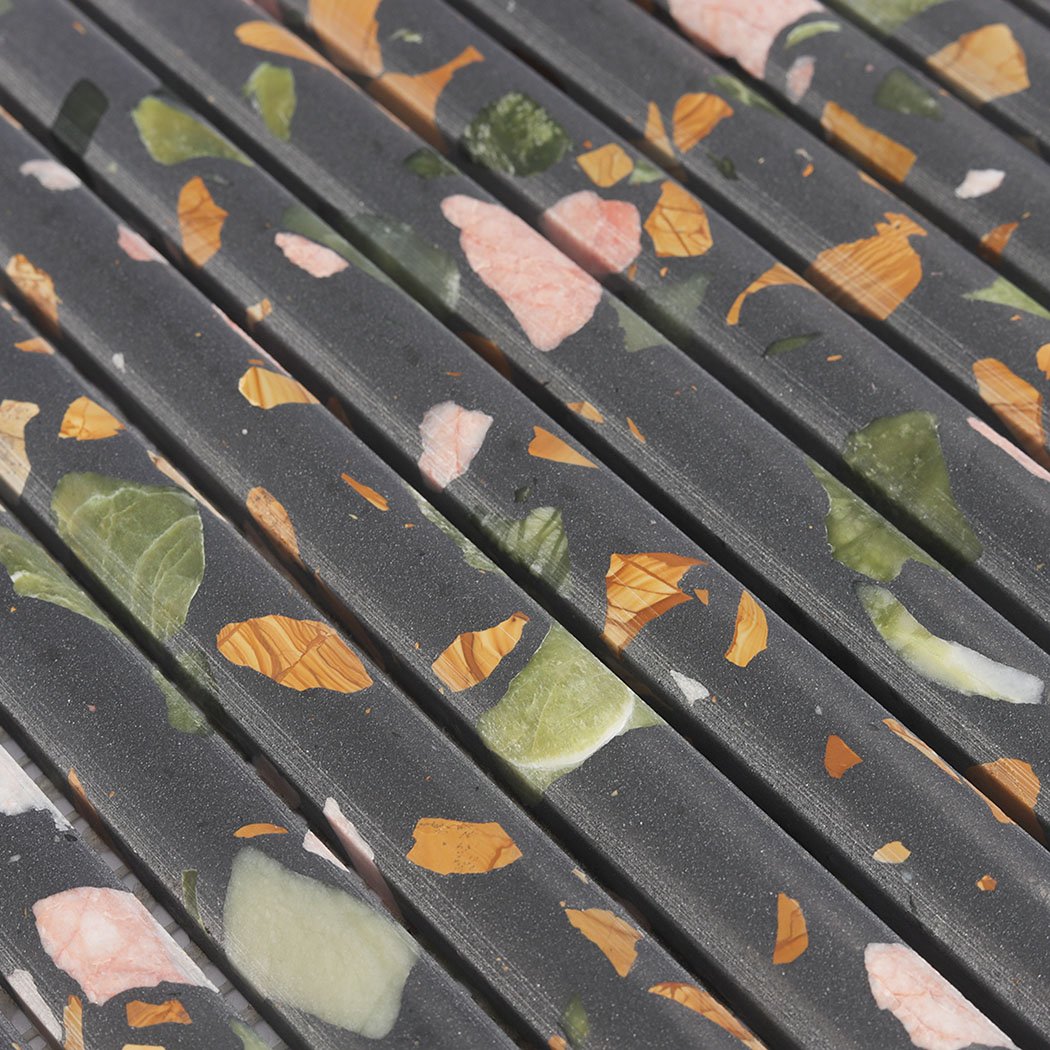 Angled detail of black terrazzo rounded fluted mosaic with multicolor chips