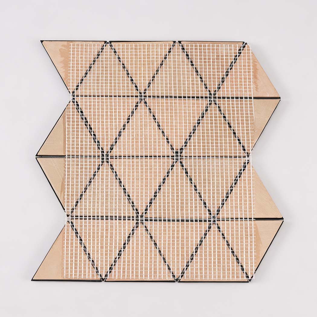 Back view of black triangle metal mosaic tile sheet with mesh mounting