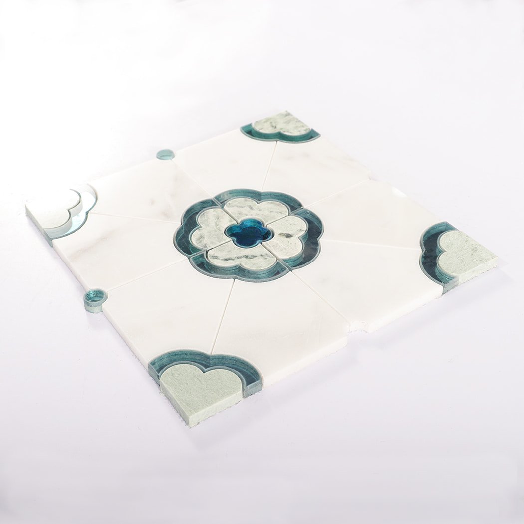 Angled view of assembled mosaic tile sheet with blue floral center and corners