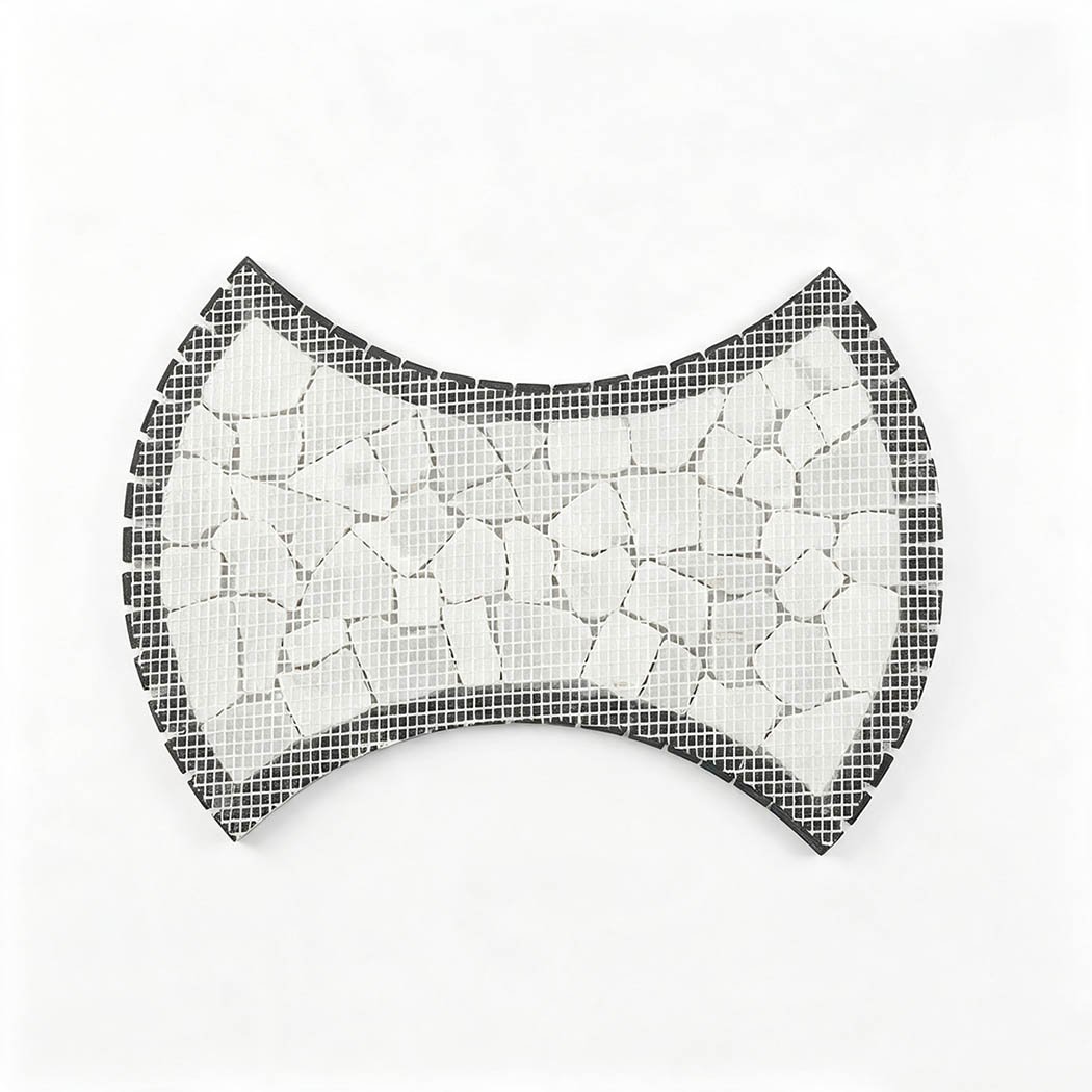 Mesh-backed reverse side of bow tie shaped white marble pebble mosaic tile