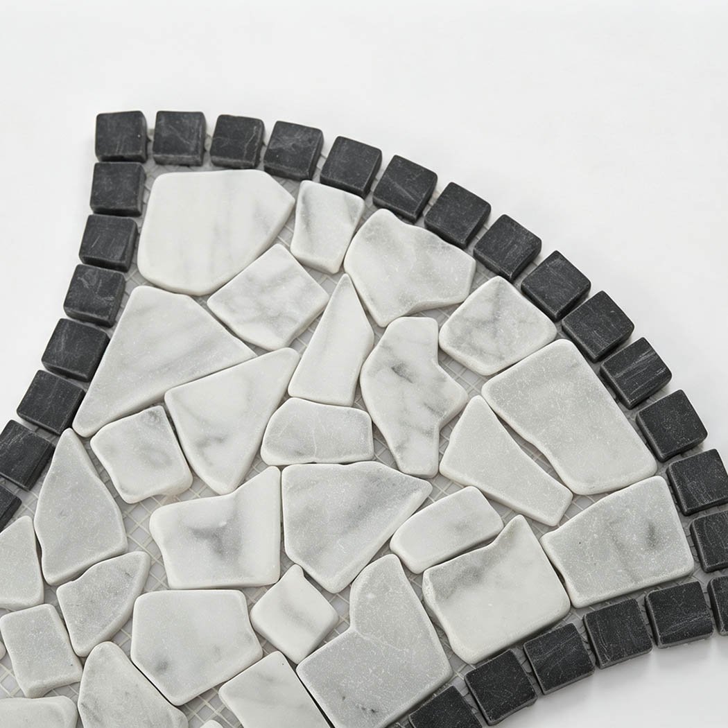 Close-up of white marble pebble mosaic with a dark charcoal border