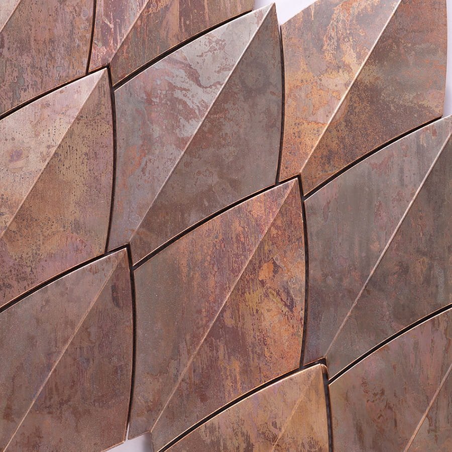 Close-up of copper diamond tiles highlighting metallic surface texture.