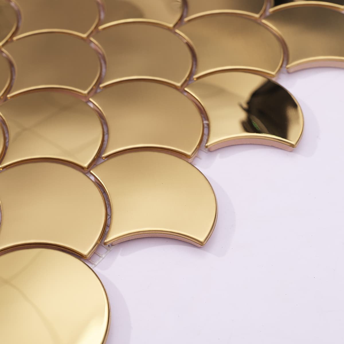 Side angle showing layered surface of gold fish scale tile
