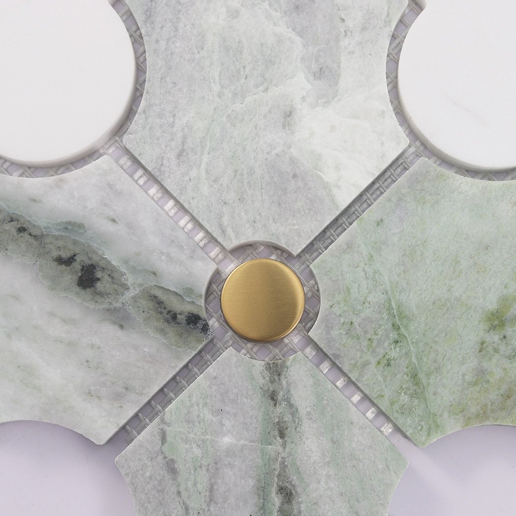 Close up of green arabesque marble mosaic with brushed gold round accent