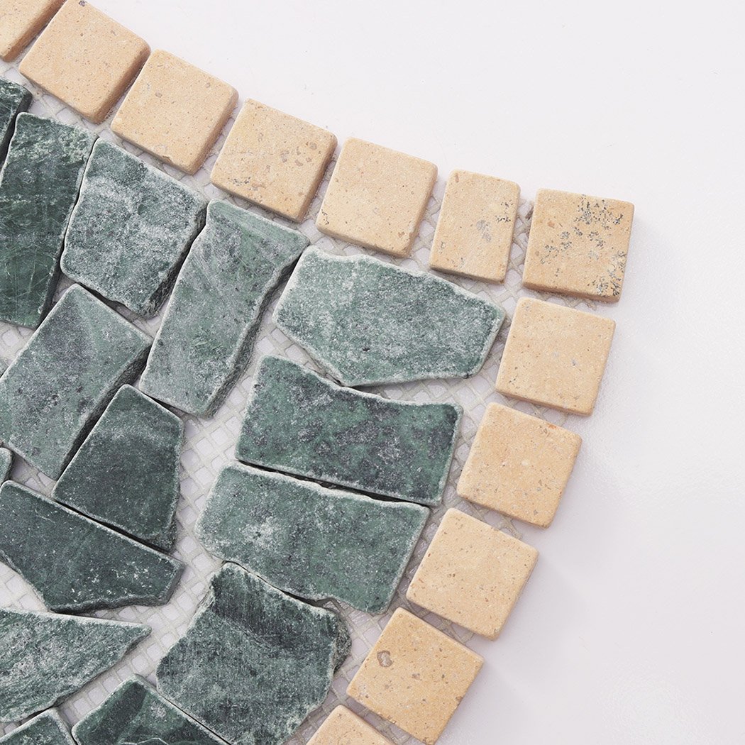 Close up of green marble pebble mosaic with beige square border tiles