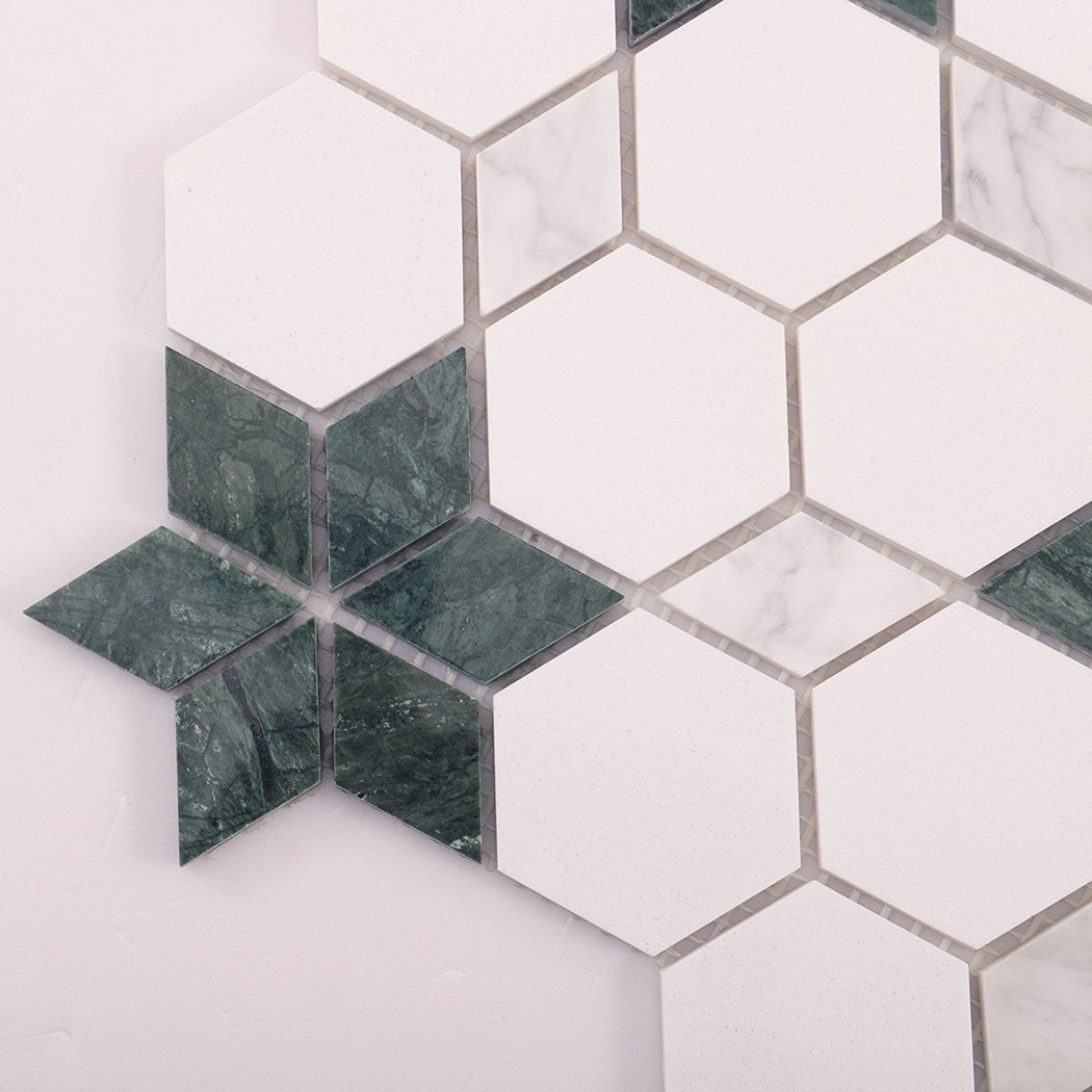 Detailed shot of dark green marble star within a white mosaic pattern.