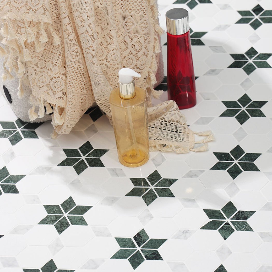 Green star marble mosaic tile with decorative bottles and a lace towel.