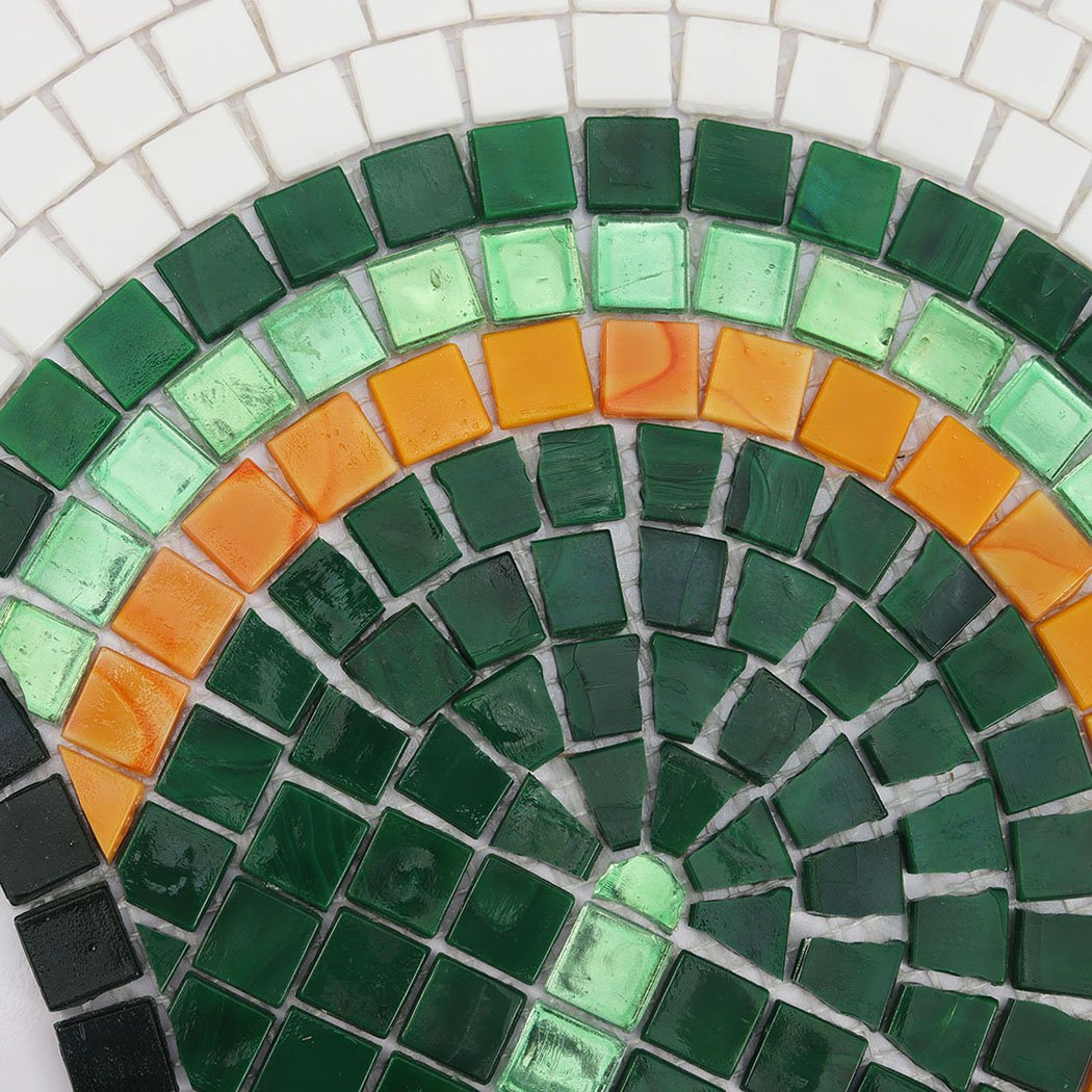 Macro view of light green iridescent glass tiles in a fan pattern.