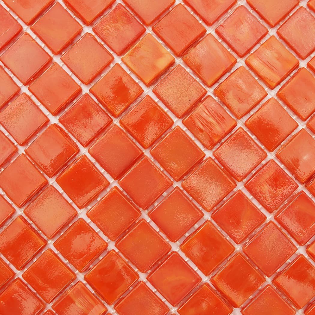 Close-up of orange square glass mosaic tile showing color variation and texture