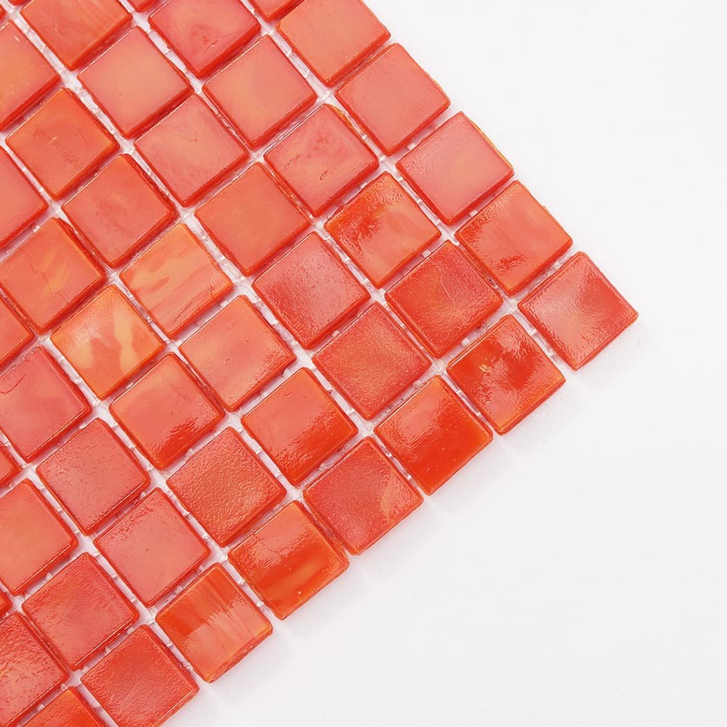 Corner detail of orange square glass mosaic tile with glossy surface