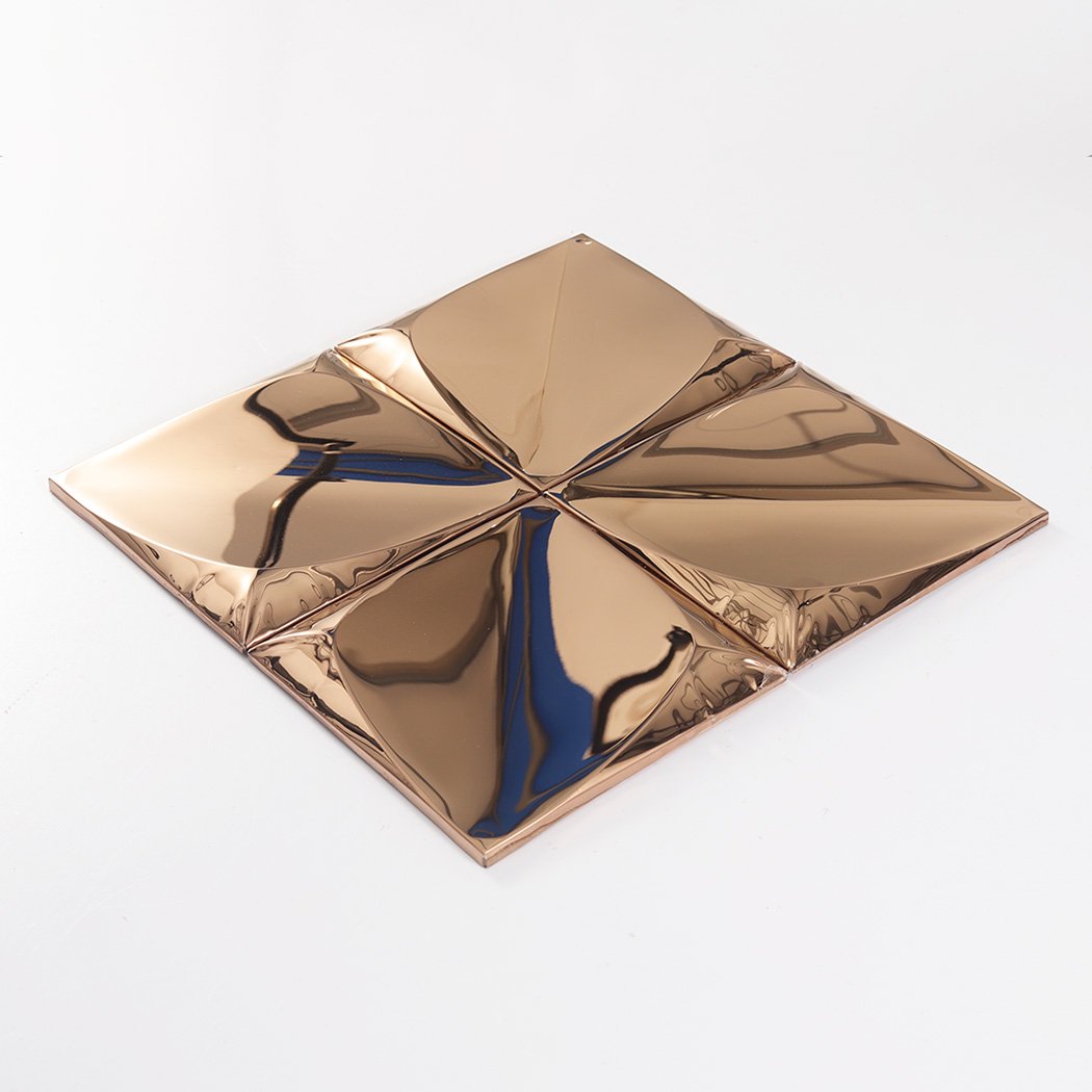 An angled perspective view of four rose gold 3D tiles joined together on a white background.