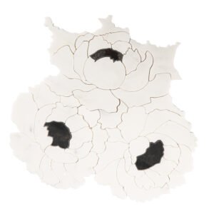 Front view of white flower-shaped marble mosaic tile with black stone accents.