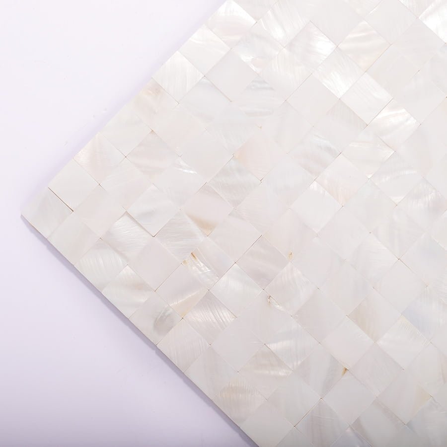 Angled view of square white mother of pearl mosaic tile sheet