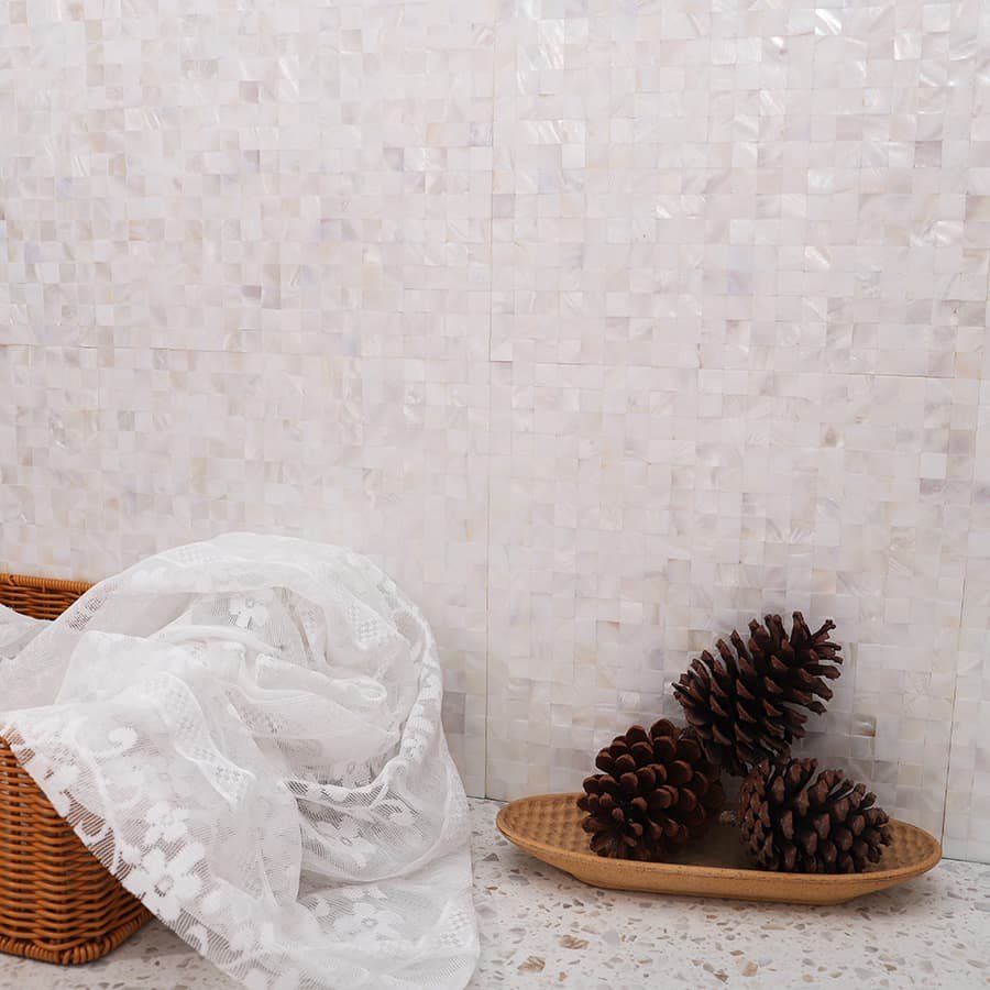 Close-up view of white shell mosaic wall tile in a cozy setup